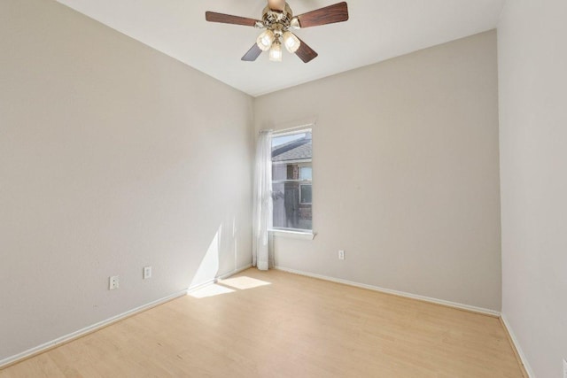 empty room with light wood finished floors, a ceiling fan, and baseboards