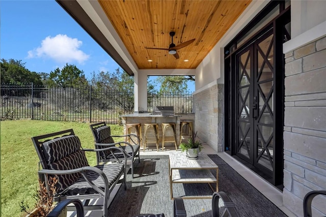 711 Twin Sails, Horseshoe Bay, TX 78657 - view of patio / terrace featuring a grill, fence, an outdoor kitchen, and a ceiling fan