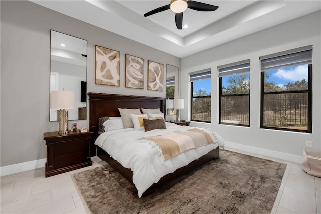 711 Twin Sails, Horseshoe Bay, TX 78657 - bedroom featuring light tile patterned floors, baseboards, a raised ceiling, and recessed lighting