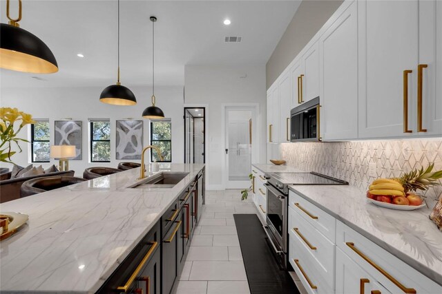 711 Twin Sails, Horseshoe Bay, TX 78657 - kitchen featuring tasteful backsplash, white cabinets, light stone counters, appliances with stainless steel finishes, and a sink