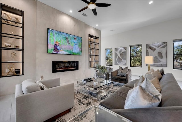 711 Twin Sails, Horseshoe Bay, TX 78657 - living room with a ceiling fan, a glass covered fireplace, visible vents, and recessed lighting