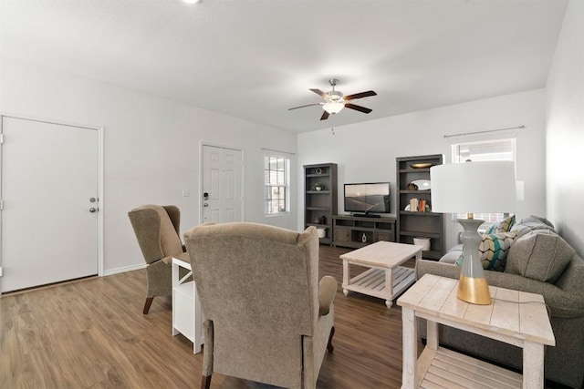 living room with wood finished floors and a ceiling fan