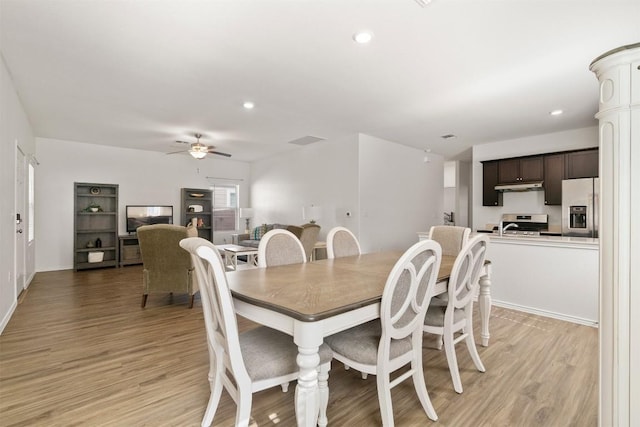 dining space featuring a ceiling fan, recessed lighting, and light wood finished floors