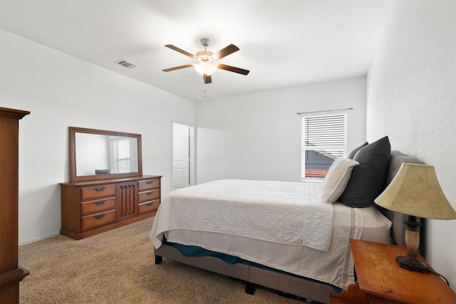 bedroom with light carpet, ceiling fan, and visible vents