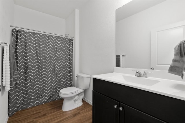 full bath featuring toilet, a shower with shower curtain, wood finished floors, and vanity