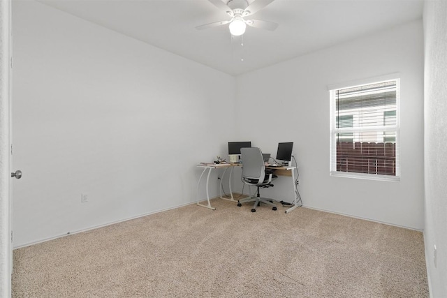 carpeted office featuring ceiling fan