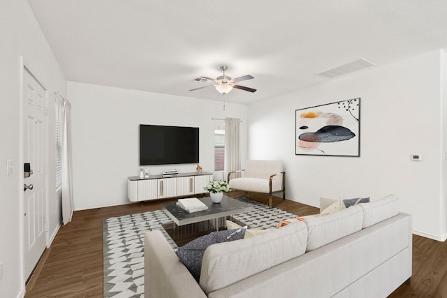 7016 Spirit Hill Rd, Austin, TX 78744 - living area with dark wood finished floors, a ceiling fan, and baseboards