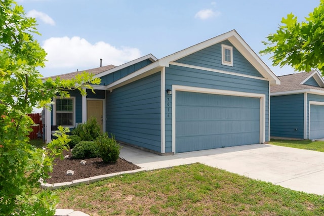 7016 Spirit Hill Rd, Austin, TX 78744 - ranch-style home featuring an attached garage, concrete driveway, and board and batten siding