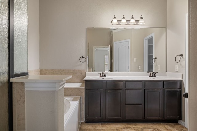 bathroom featuring a bath, double vanity, and a sink