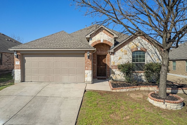 french country inspired facade featuring a garage, driveway, stone siding, roof with shingles, and brick siding