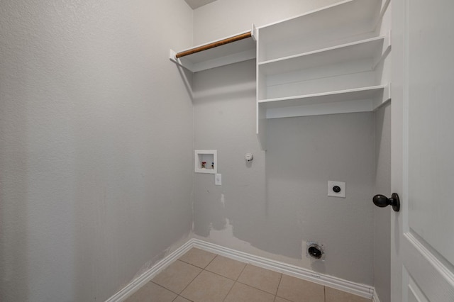 laundry area featuring light tile patterned floors, laundry area, gas dryer hookup, hookup for a washing machine, and hookup for an electric dryer