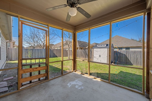 unfurnished sunroom with ceiling fan