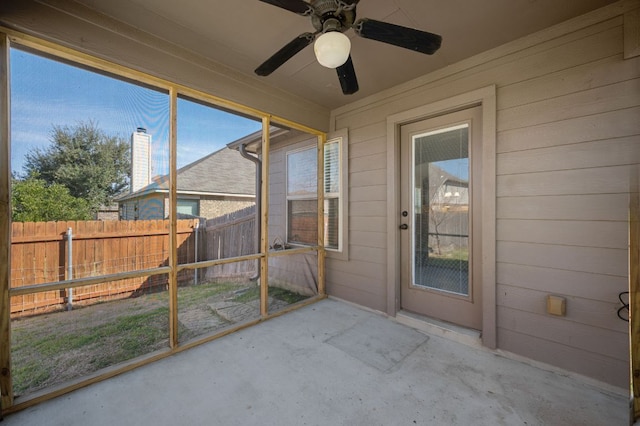 unfurnished sunroom with a ceiling fan