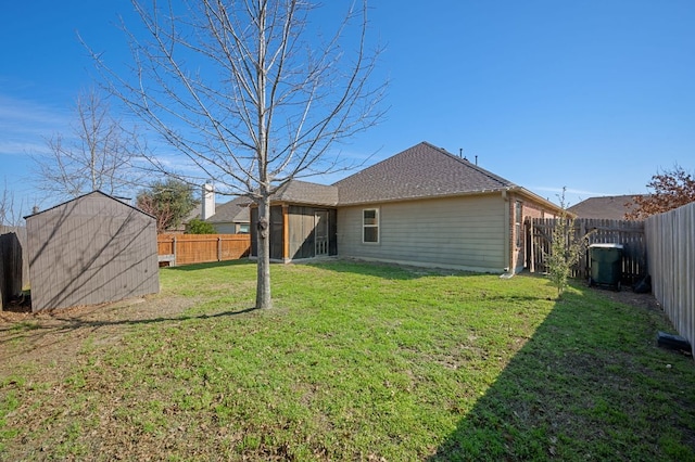 back of house with an outbuilding, a fenced backyard, a yard, and a storage unit