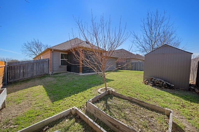 view of yard with a fenced backyard, a vegetable garden, an outdoor structure, and a storage shed