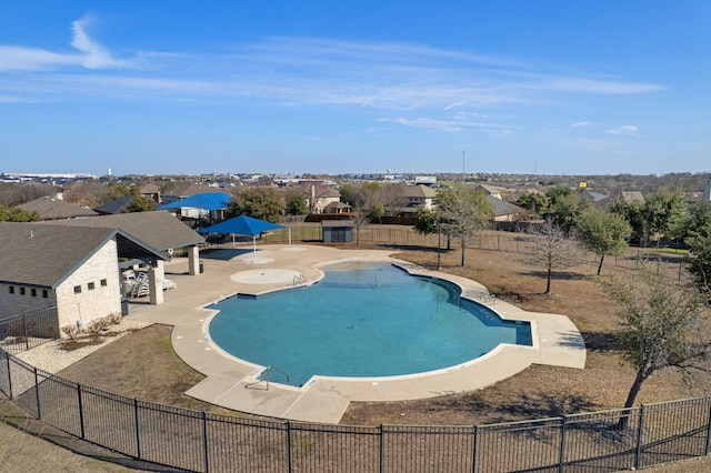 pool with a residential view, a patio, and fence