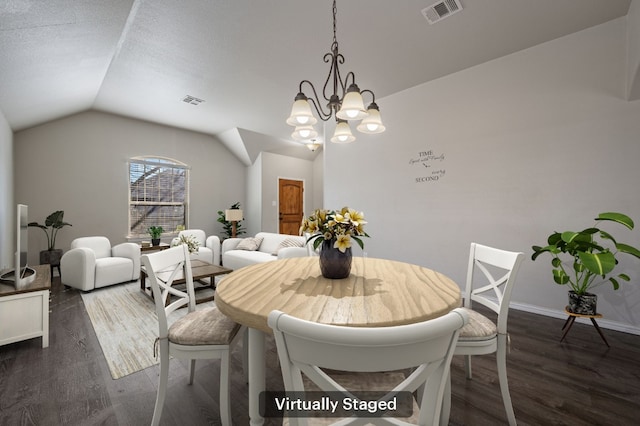 dining area with visible vents, vaulted ceiling, and wood finished floors