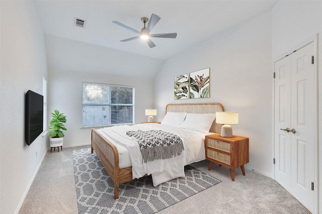 carpeted bedroom with lofted ceiling, ceiling fan, visible vents, and baseboards