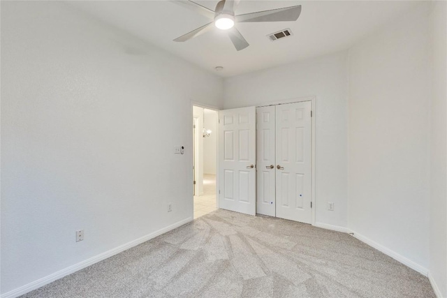 unfurnished bedroom with baseboards, a closet, visible vents, and carpet flooring