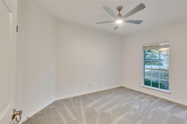 empty room with light carpet, ceiling fan, and baseboards