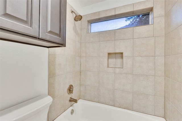 bathroom featuring shower / bathtub combination and toilet