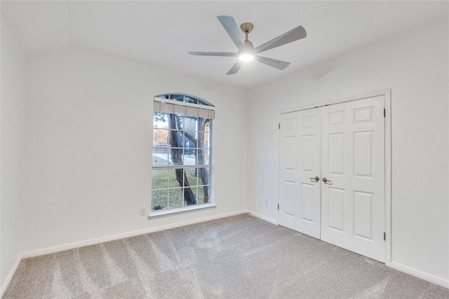 unfurnished bedroom featuring a ceiling fan, a closet, baseboards, and carpet flooring