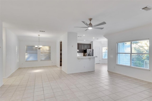 unfurnished living room featuring light tile patterned floors, recessed lighting, visible vents, and ceiling fan with notable chandelier