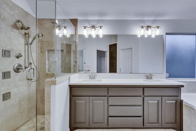 bathroom with a washtub, a sink, a shower stall, and double vanity