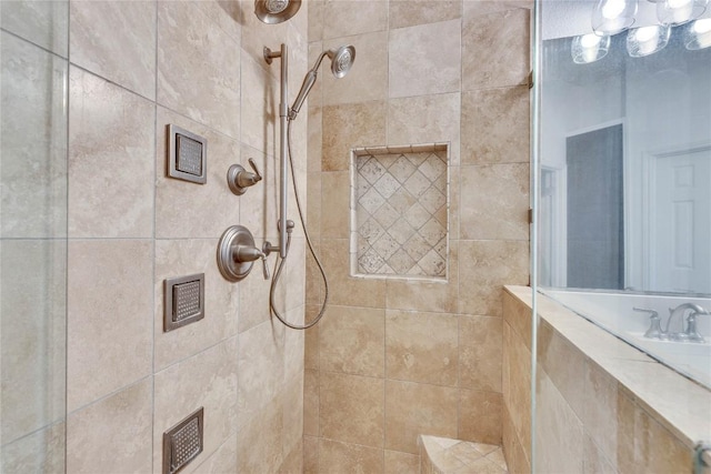 full bath with a tile shower