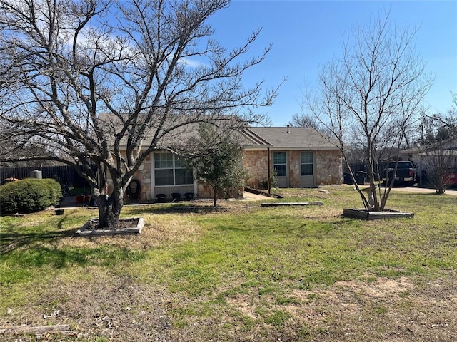 ranch-style house with stone siding, fence, and a front lawn