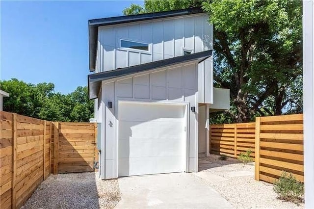 garage featuring fence and driveway