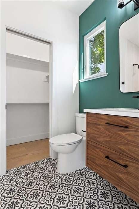 bathroom with vanity, toilet, and tile patterned floors