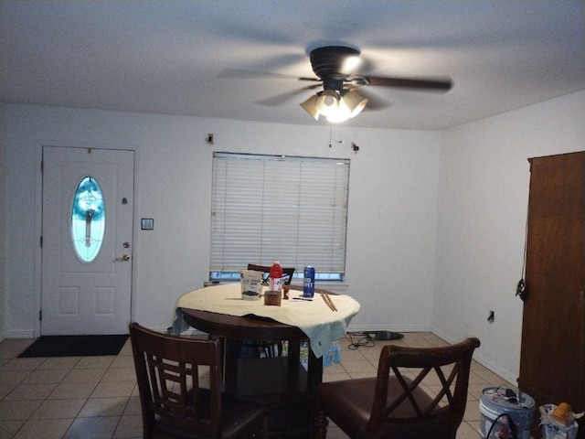 dining space featuring tile patterned flooring, baseboards, and ceiling fan