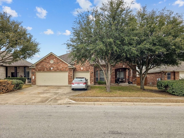 view of front of property with an attached garage, driveway, roof with shingles, and brick siding