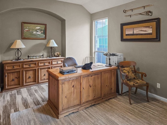 office space with vaulted ceiling and light wood-type flooring