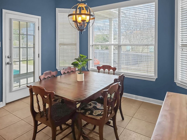 dining area featuring a chandelier, baseboards, and light tile patterned floors