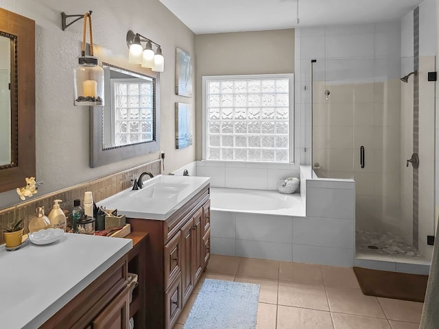 full bath featuring a healthy amount of sunlight, a stall shower, a garden tub, and tile patterned floors