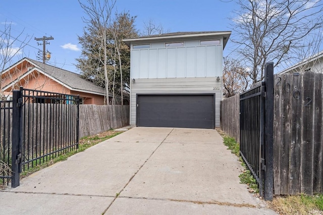 exterior space with concrete driveway and fence