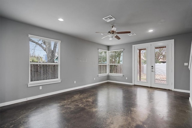 unfurnished room with finished concrete flooring, baseboards, and visible vents