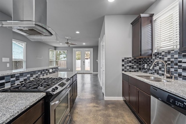 kitchen featuring appliances with stainless steel finishes, a sink, dark brown cabinetry, and island range hood