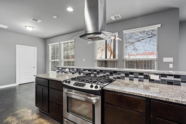 kitchen featuring exhaust hood, visible vents, finished concrete flooring, and gas range