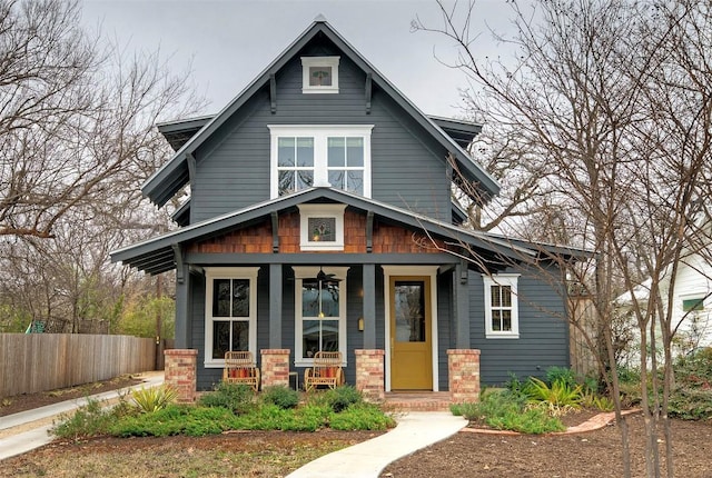 view of front facade featuring covered porch and fence