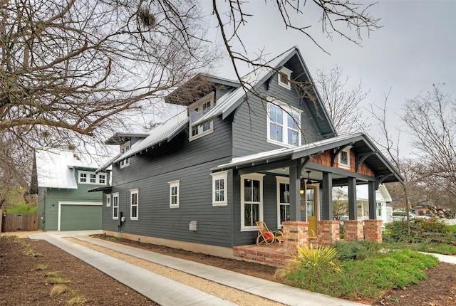 view of home's exterior featuring covered porch and a garage