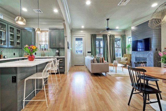 kitchen with light wood-type flooring, visible vents, and open floor plan