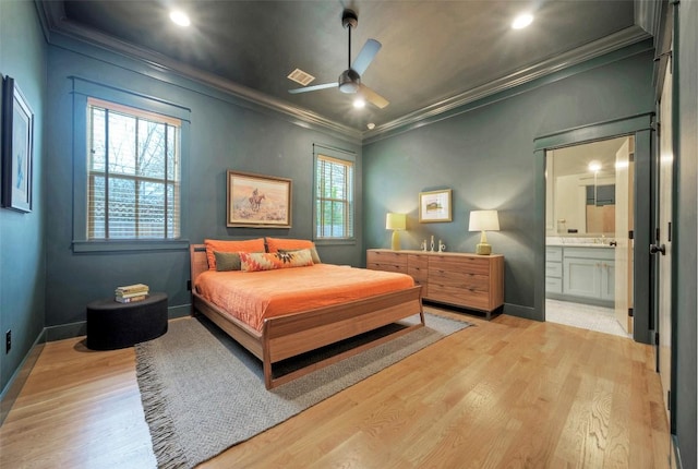 bedroom featuring light wood finished floors and crown molding