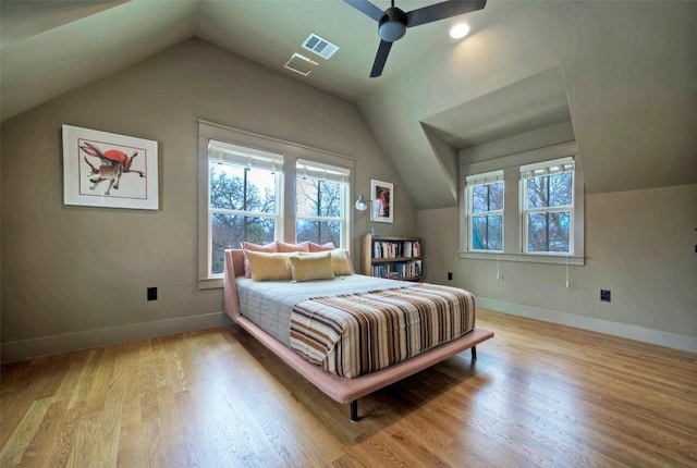 bedroom featuring visible vents, ceiling fan, vaulted ceiling, wood finished floors, and baseboards