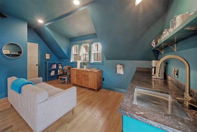 interior space with light wood-style floors, recessed lighting, vaulted ceiling, and baseboards