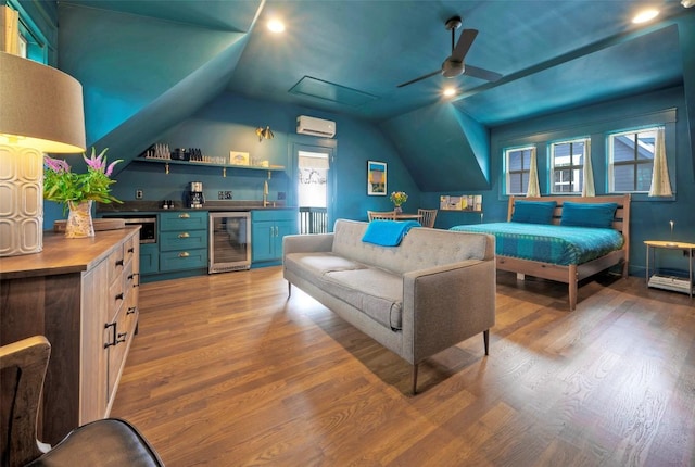 interior space featuring lofted ceiling, wine cooler, a wall unit AC, wood finished floors, and a dry bar