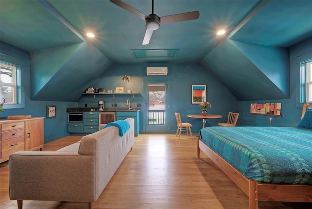 bedroom featuring wine cooler, indoor wet bar, a wall unit AC, vaulted ceiling, and light wood-type flooring