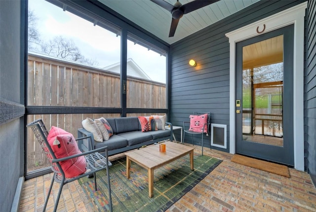 sunroom with a ceiling fan